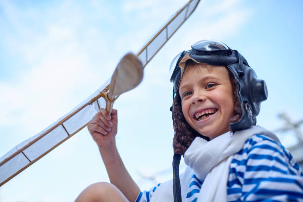 istock Children run the plane into the sky 695455840