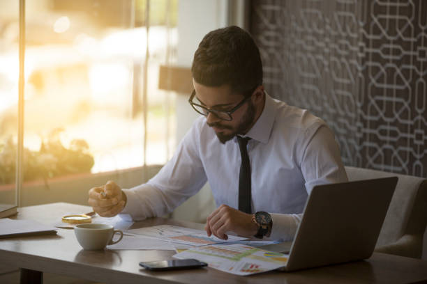 istock Young businessman showing graphs by pen 695457788
