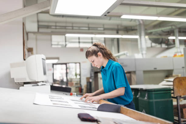 istock Female designer working at printing factory 695460954