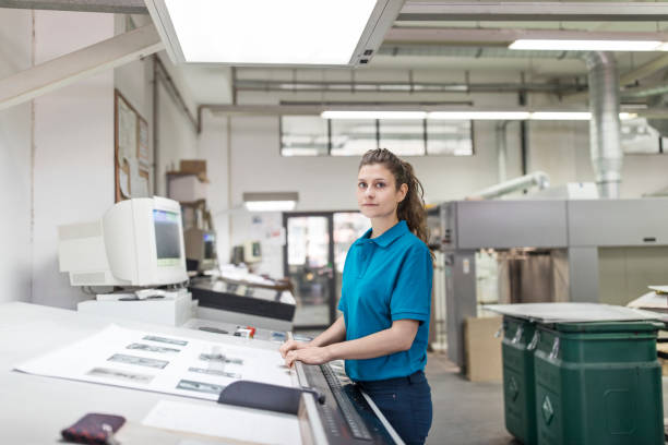 istock Female designer working at printing house 695461356