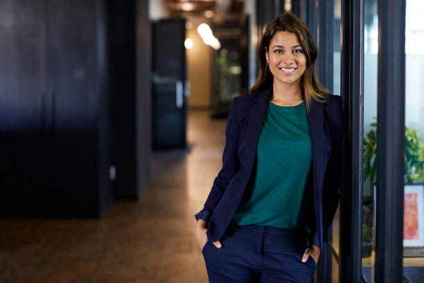 istock Businesswoman with hands in pockets at office 695461424