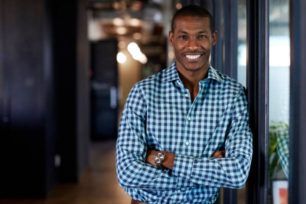 istock Businessman with arms crossed smiling in office 695461430