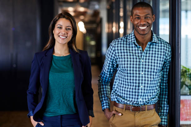 istock Multi-ethnic business people with hands in pockets 695461558