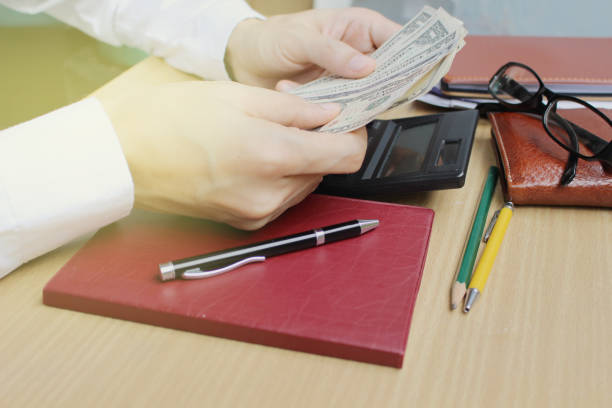 istock Man counting money in home office 695461572