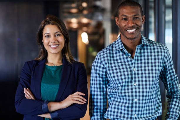 istock Multi-ethnic business colleagues smiling in office 695461574