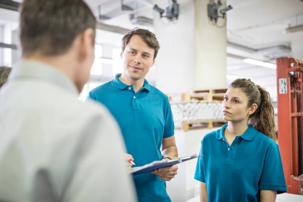 istock Printing press professionals having a meeting in plant 695461610