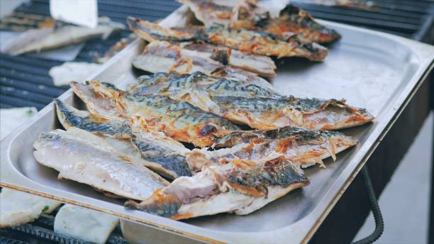 istock Grilled scomber fish on a tray. Outdoor summer barbecue 695461850