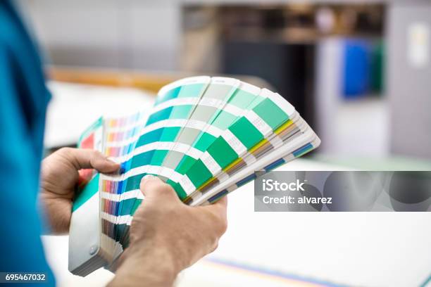 Man Hands With Colour Samples At Printing Press Stock Photo - Download Image Now - Color Swatch, Colors, Printing Press