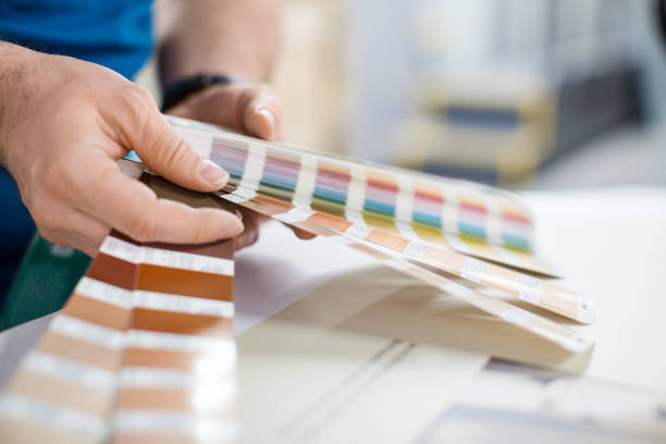 istock Designer working with color palette at printing press 695467256