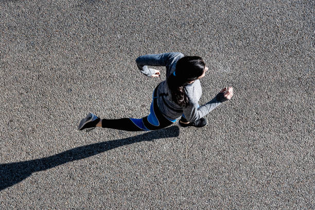 istock Top view of young woman jogging 695473896