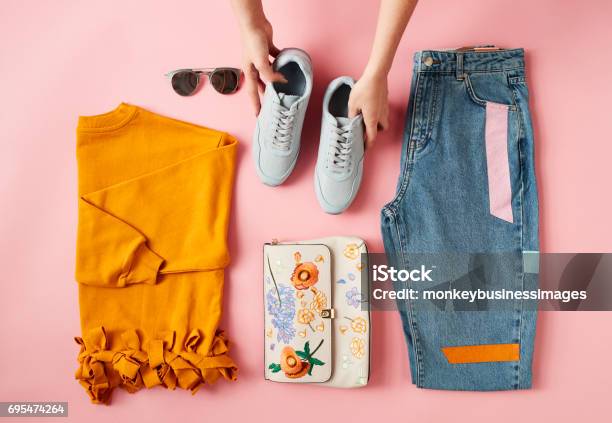 Hands Arranging Flat Lay Shot Of Female Autumn Clothing Stock Photo - Download Image Now