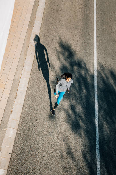 istock Top view of young woman jogging 695476818