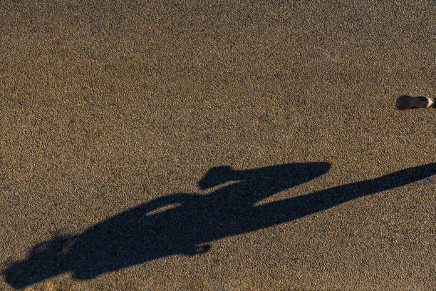 istock Shadow of young woman jogging 695476820