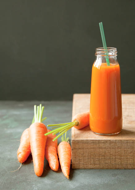 istock A bottle of fresh carrot juice. 695480066