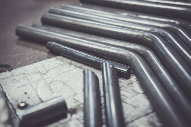 Bent steel pipe on a work bench. stock photo