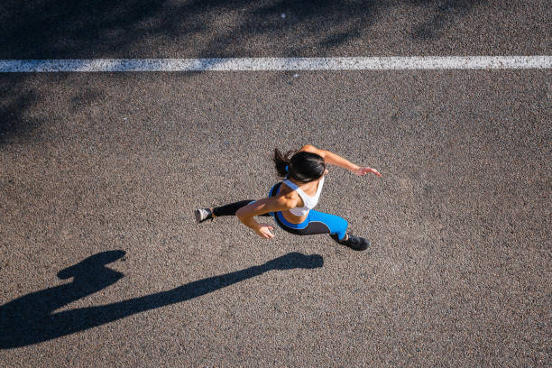 istock Top view of young woman jogging 695484046