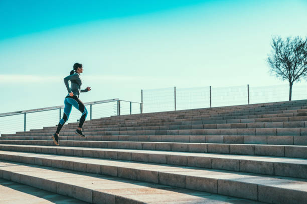 istock Young woman jogging on stairs 695484082