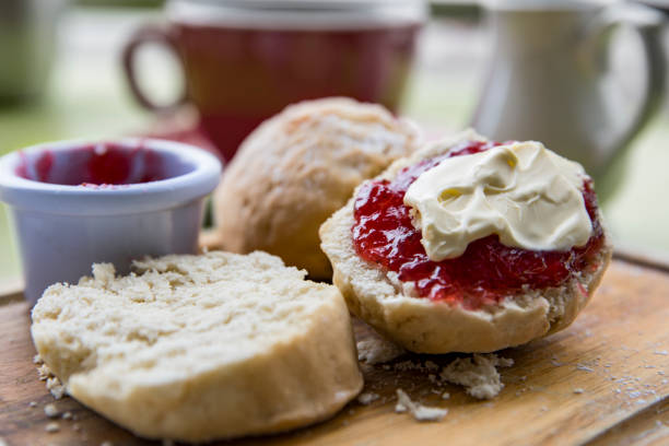 English Cream tea with scones jam and cream English Cream tea with scones jam and clotted cream and cup of tea cornwall england stock pictures, royalty-free photos & images