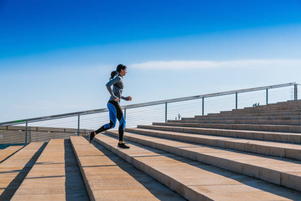 istock Young woman jogging on stairs 695484842