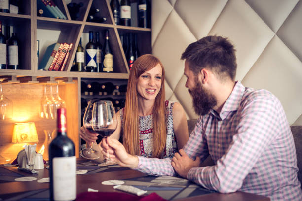 istock Couple celebrating anniversary in stylish restaurant 695485232