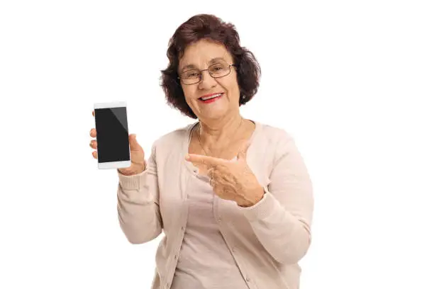 Photo of Elderly woman holding a phone and pointing