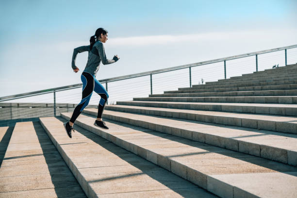 istock Young woman jogging on stairs 695485810