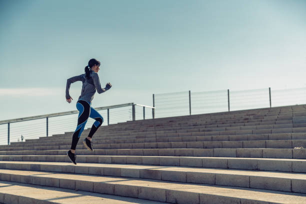istock Young woman jogging on stairs 695486064