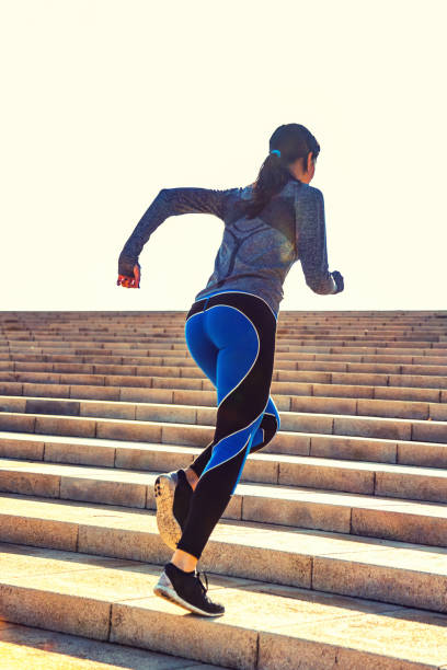 istock Young woman jogging on stairs 695486314