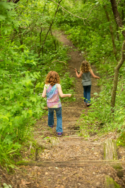 istock Two Young Girls on Stairway Trail Through Woods 695488860