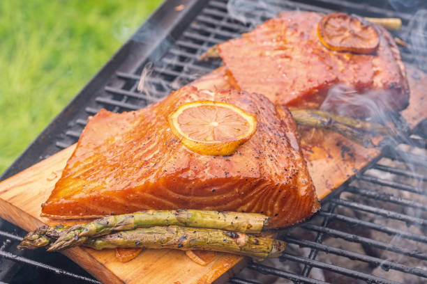 istock cedar plank salmon with lemon on a grill 695502346