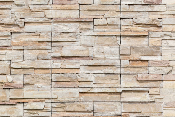 istock The white brown stone on concrete wall, textured wall background. 695505772