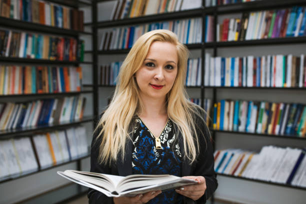 istock Education concept. Blonde woman with a book. 695508452