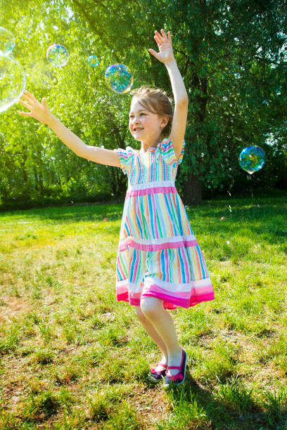 istock Girl Catch Soap Bubbles 695508702