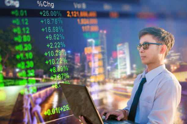 istock Asian business man using laptop and digital tablet in Singapore 695512516