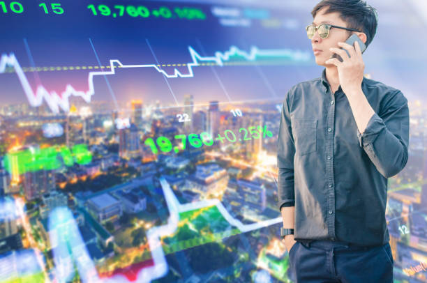 istock Young business man using laptop and digital tablet cityscape background 695512878