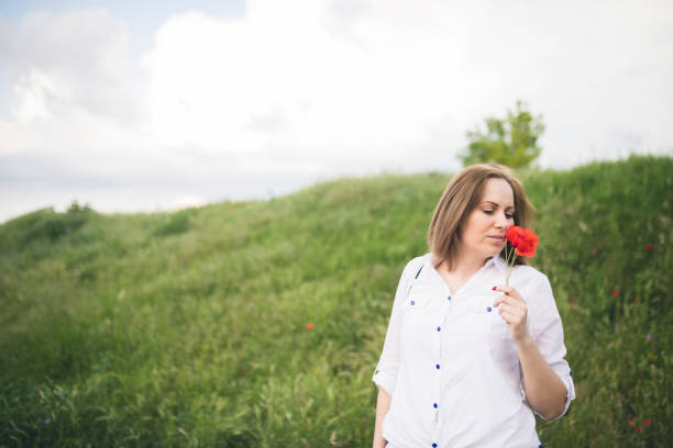 istock Young woman in poppies 695515576