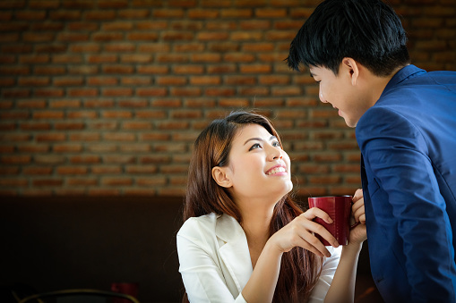Young romantic couple Smiling happy in a cafe