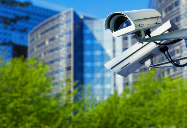 istock cctv security camera in a city with blury business building on background 695519280