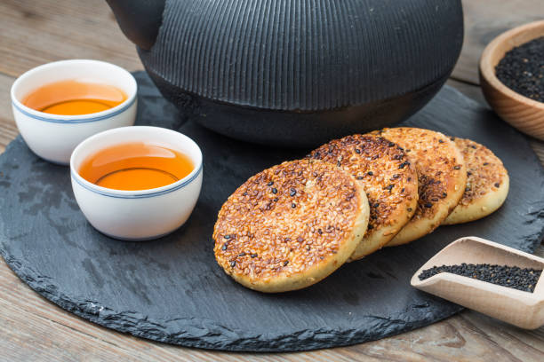 istock The teapot and tea on the wooden table, delicious snacks 695519384
