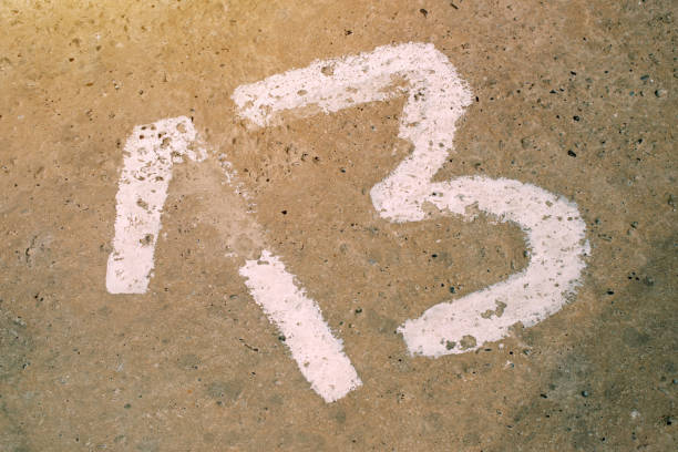 istock Number thirteen on the concrete floor 695520016