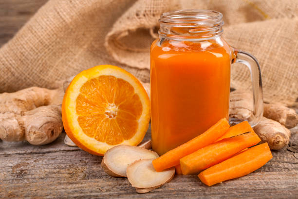 healthy detox drink - orange smoothie imagens e fotografias de stock