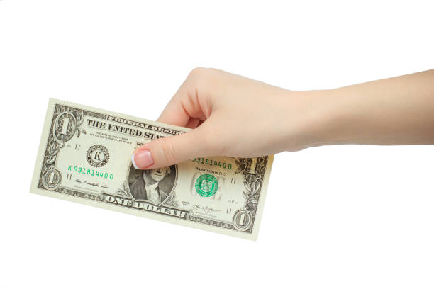 istock woman hand holding one dollar isolated on white background 695531548