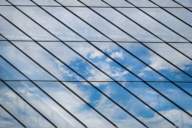 istock Glass roof Mirror Reflection On Sky and cloud 695533752