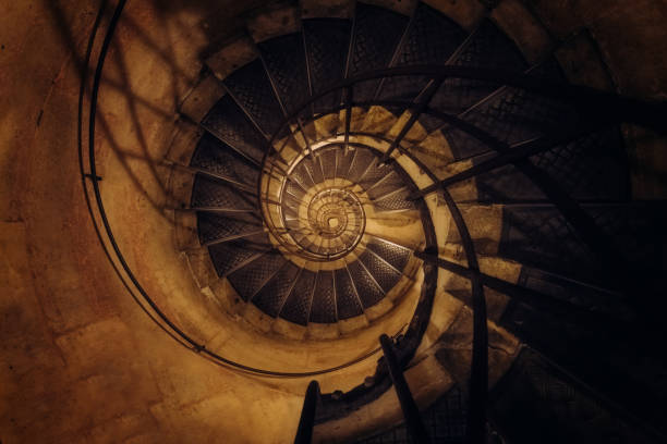 Minimalist staircase going up to the light in a dark room