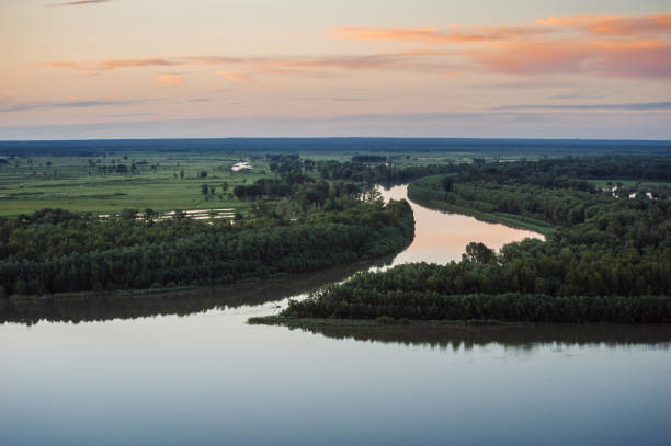 istock Mirror surface of water at sunset 695538244
