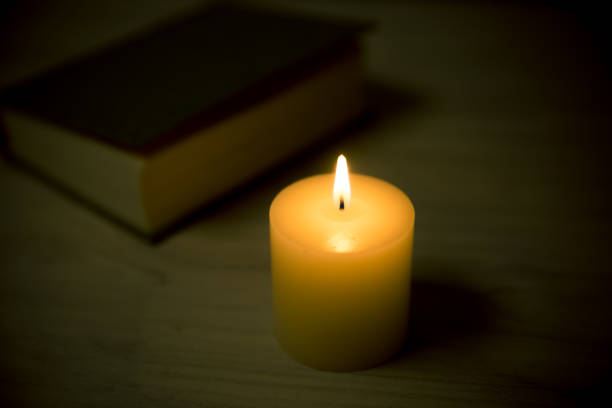 istock candles and book in the background 695548024