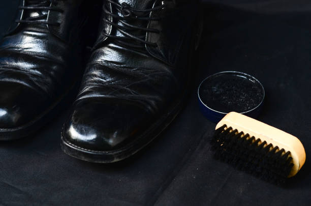 istock Businessman cleaning shoes 695548366