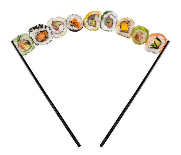Sushi pieces placed between chopsticks on white background
