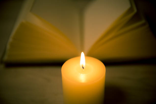 istock candles and book in the background 695548626