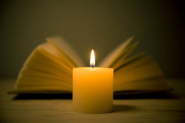 istock candles and book in the background 695548752